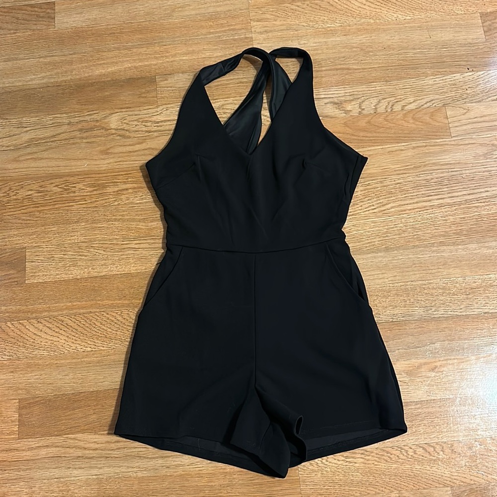 Open back black romper. NWT